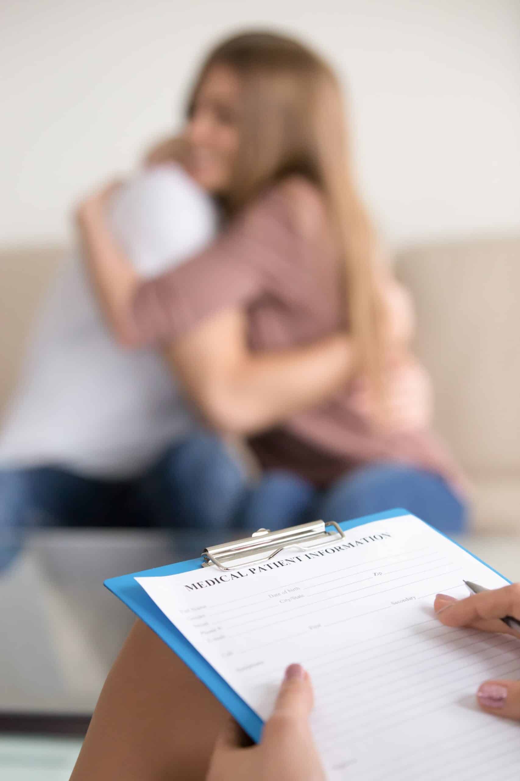female family psychologist filling information about couple medical card scaled