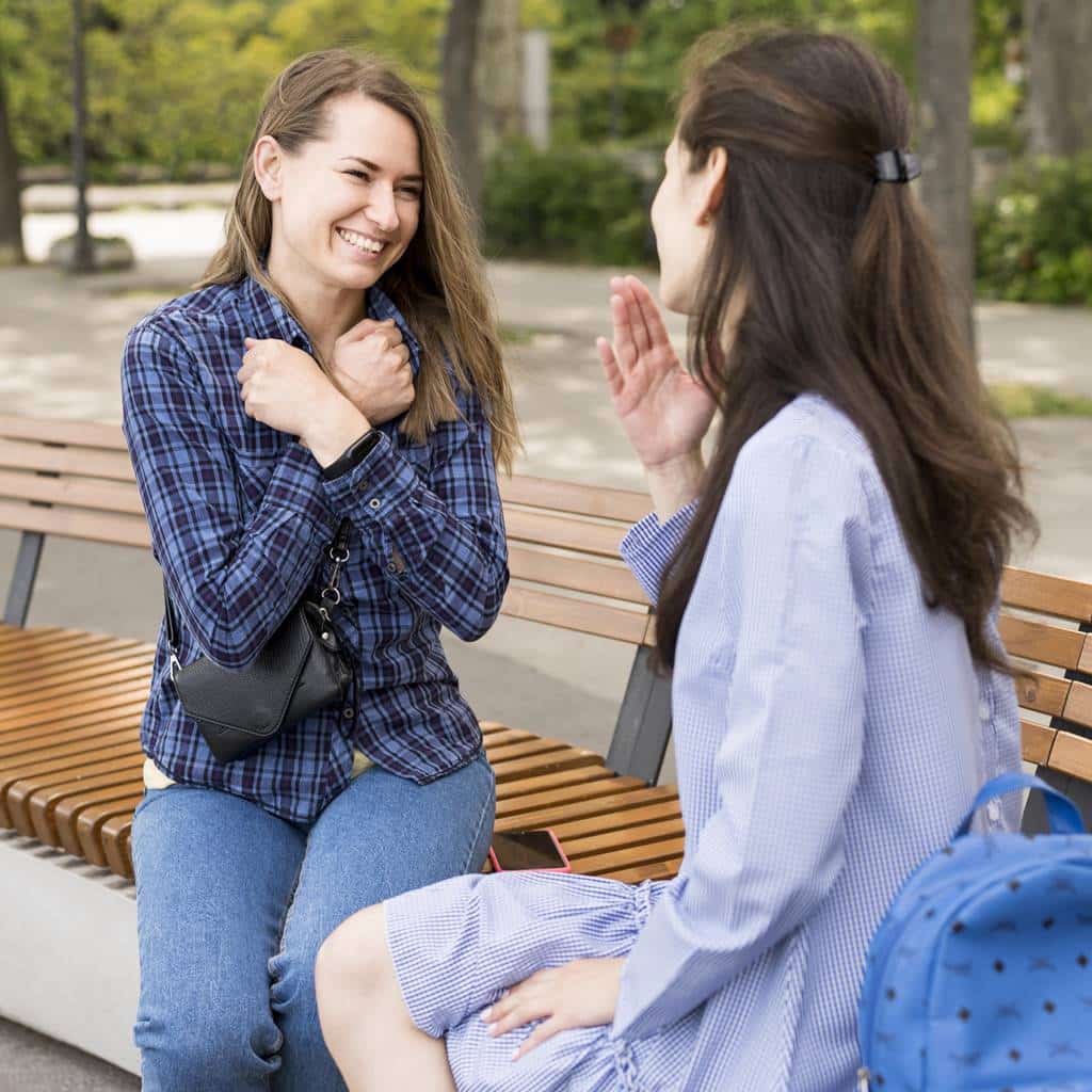 adult women communicating through sign language