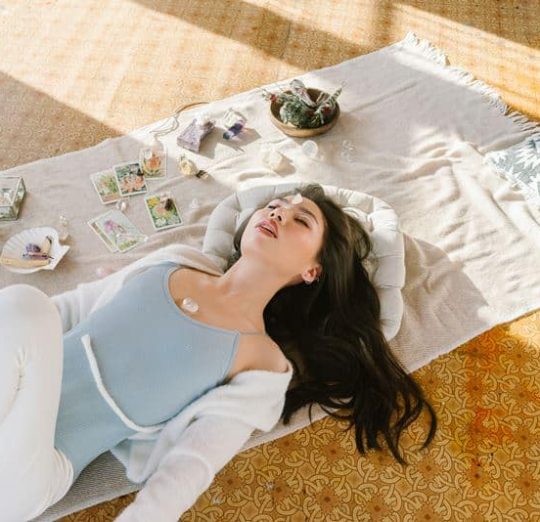 Woman relaxing with crystals for postpartum depression relief, wellness and self-care after childbirth. Healing meditation.