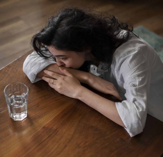 Young woman experiencing anxiety, seeking PTSD treatment. Depicts stress and the need for mental health support.